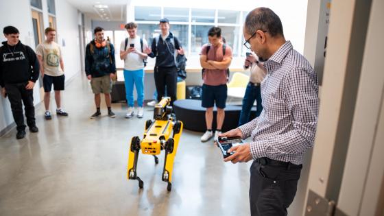 people operating a robotic dog