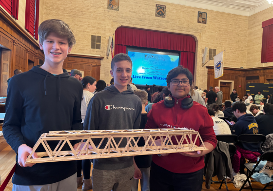 kids holding up a model bridge