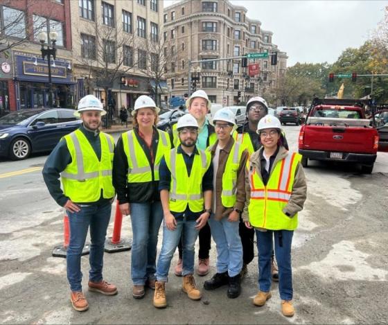 a group of people in the city wearing hard hats