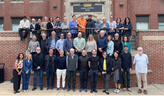 a large group of people standing in front of a brick building