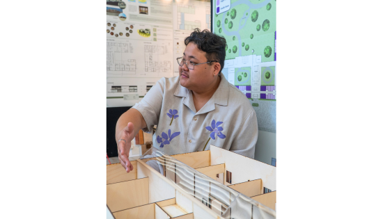 a student presents a model of a memory care facility