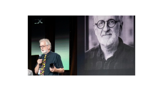a man speaks on stage at an awards event