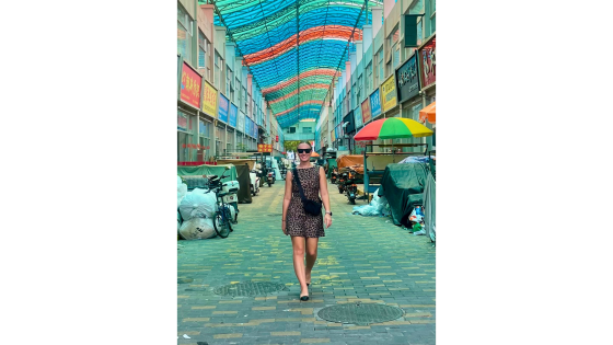 a woman walking down a colorful street