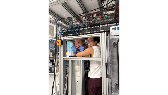 two women in front of a machine