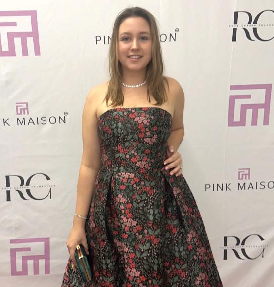 a woman in a dress on a red carpet