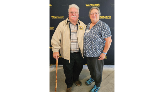 two people standing in front of a wentworth background