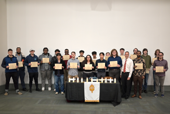 a large group of people holding certificates