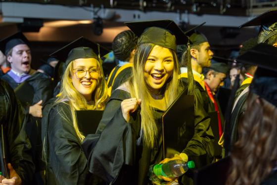 very happy students in graduation robes