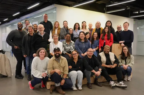 a large group of people posing for a photo together