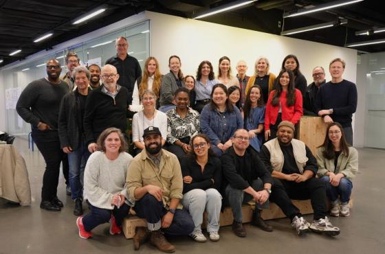 a large group of people posing for a photo together