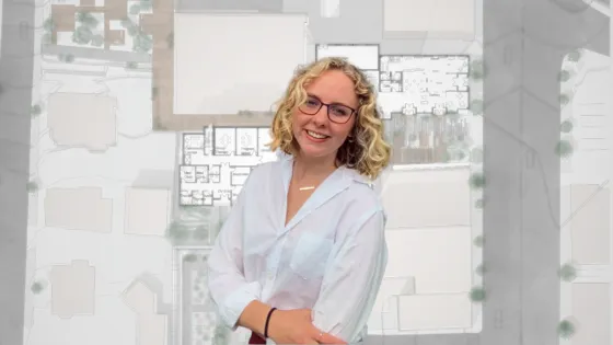 a woman stands in front of a architectural rendering