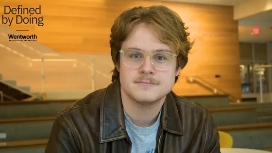 portrait of a man wearing glasses and a leather jacket