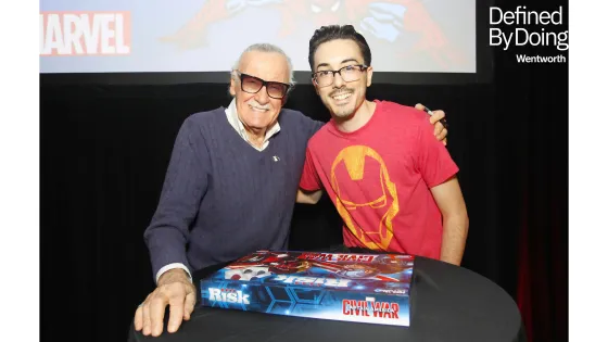 two men pose with a board game