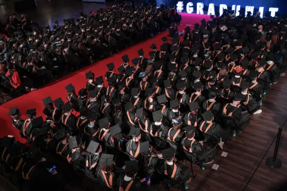 rows of students wearing graduation caps