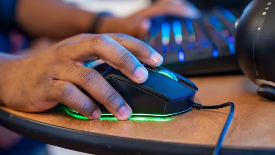 a hand on a computer mouse