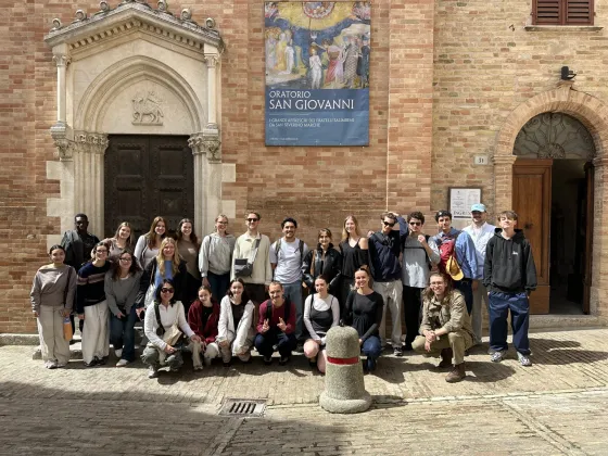 students in front of a european building