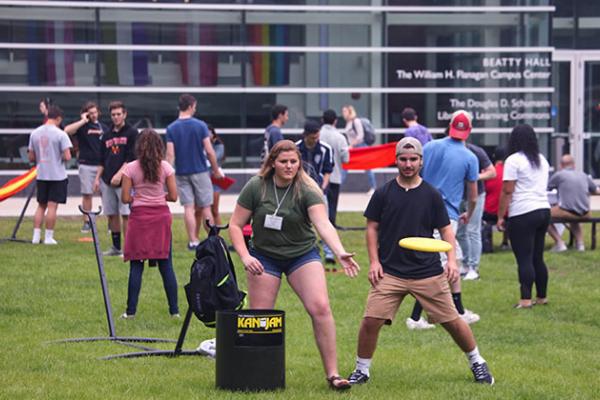 A group of students play frisbee on the Quad.