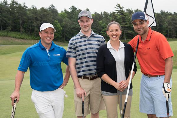 Alumni at a networking golf tournament.