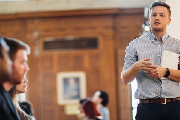 Graduate student makes final presentation to peers.