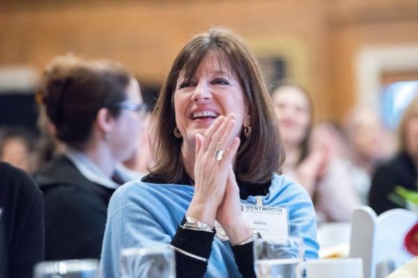 woman sitting at table and smiling