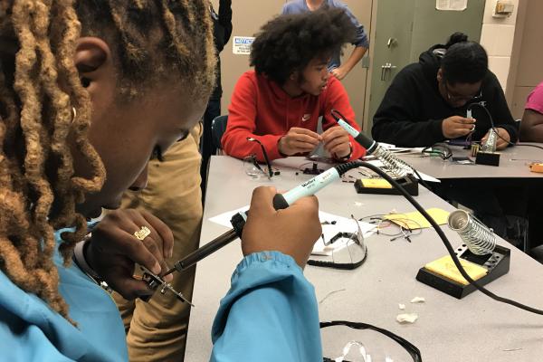 Students building circuits in a lab.