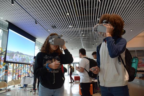 two students wearing virtual reality goggles
