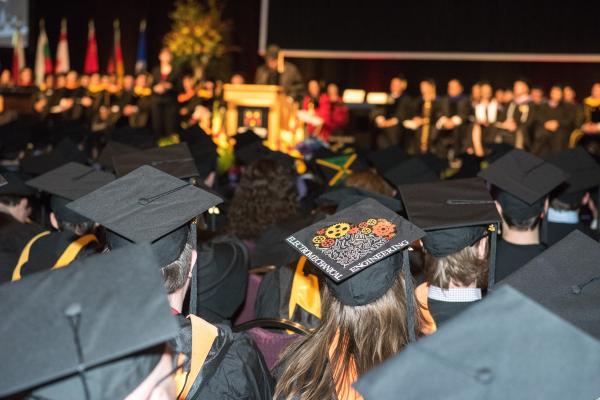 group of people wearing graduation caps