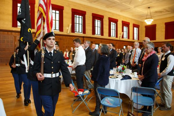Military Color Guard Carry Flags While Lunch Attendees Look On