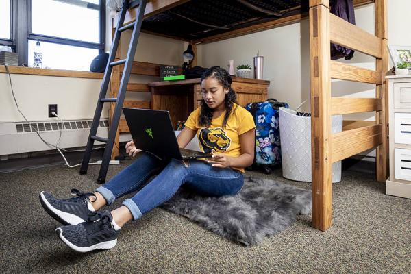 Student on laptop in dorm