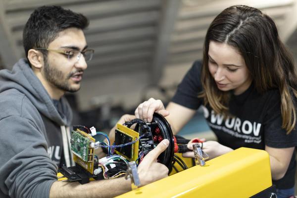 two students working on robotics project