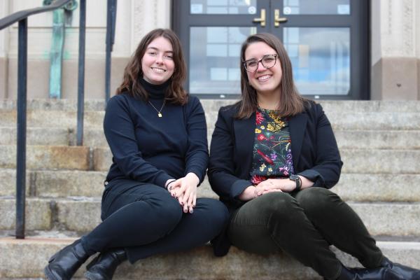 International Admissions Team members sitting on the steps of Wentworth Hall