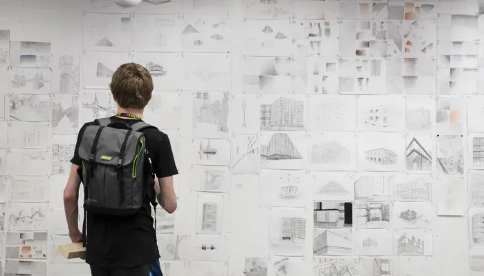 Student looking at sketches