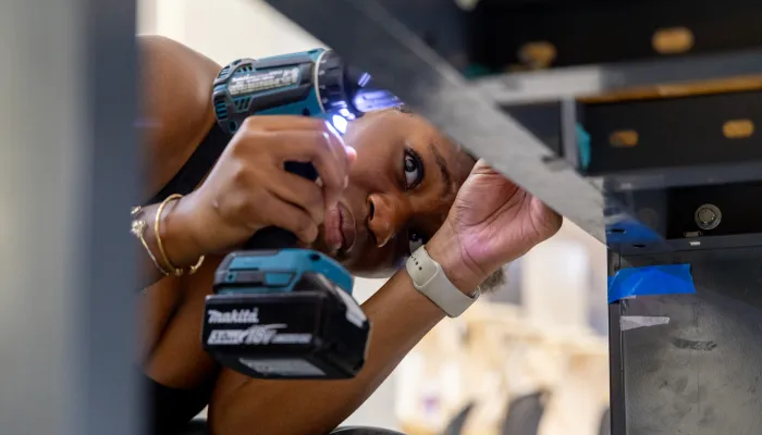 Student working with power tool in architecture studio