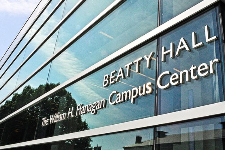 The sign on the glass outside of Beatty Hall that reads "Beatty Hall. The William H. Flanagan Campus Center"