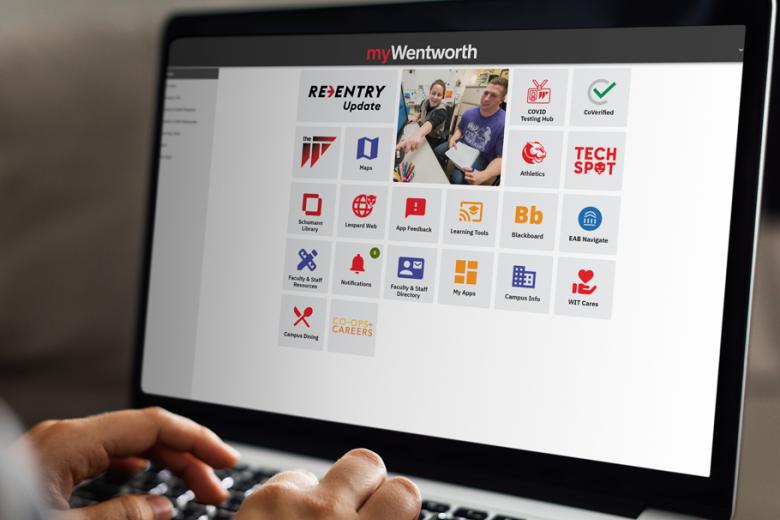 A closeup of hands on a laptop featuring the myWentworth website. 