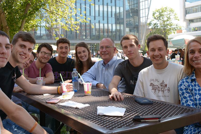 Staff and students hang out on the campus Quad.