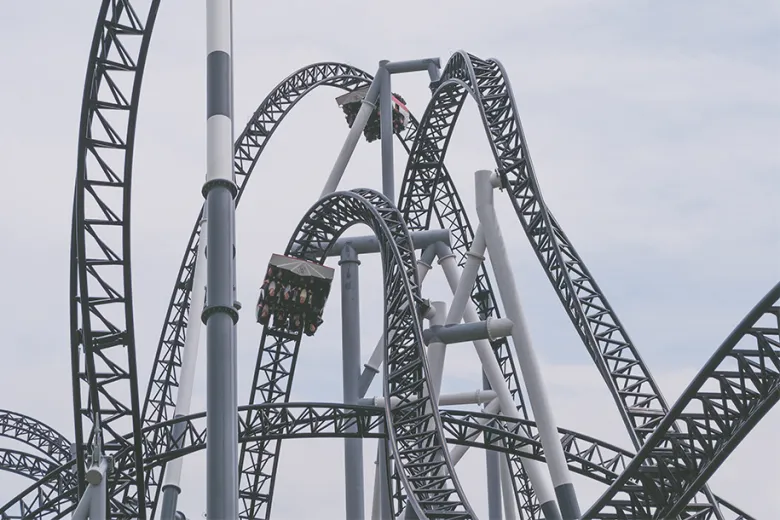A roller coster with the passengers upside down in a loop. 