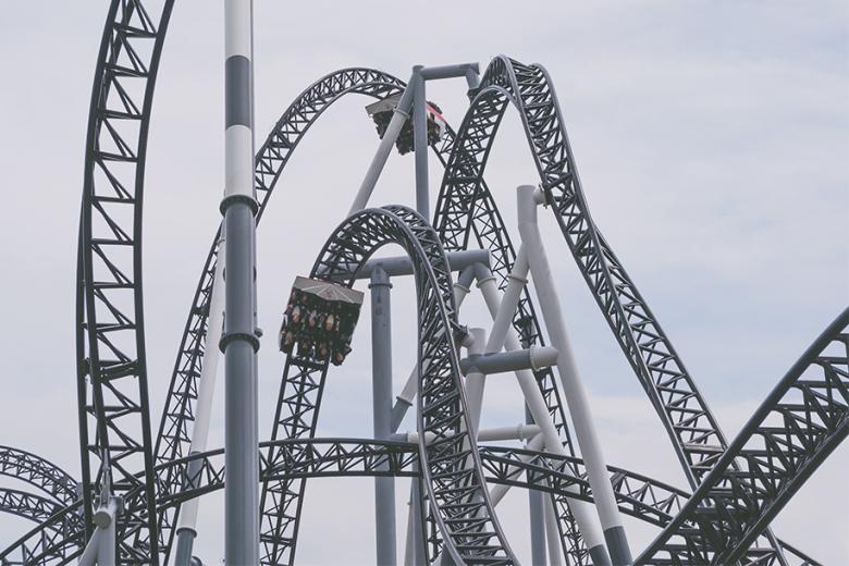 A roller coster with the passengers upside down in a loop. 