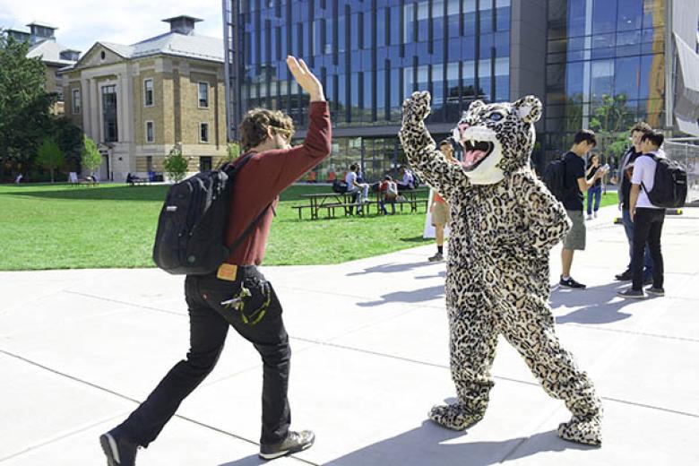 student and Wentworth leopard high-fiving