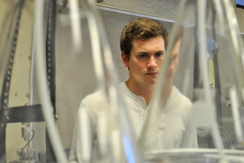 A student examines a piece of equipment