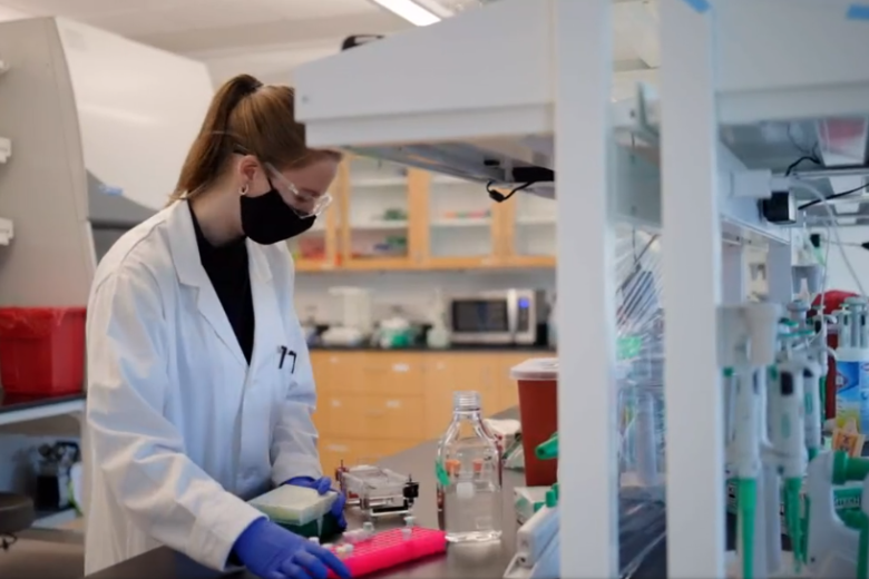 Biomedical student in laboratory, Lab coat, Safety goggles, test tubes