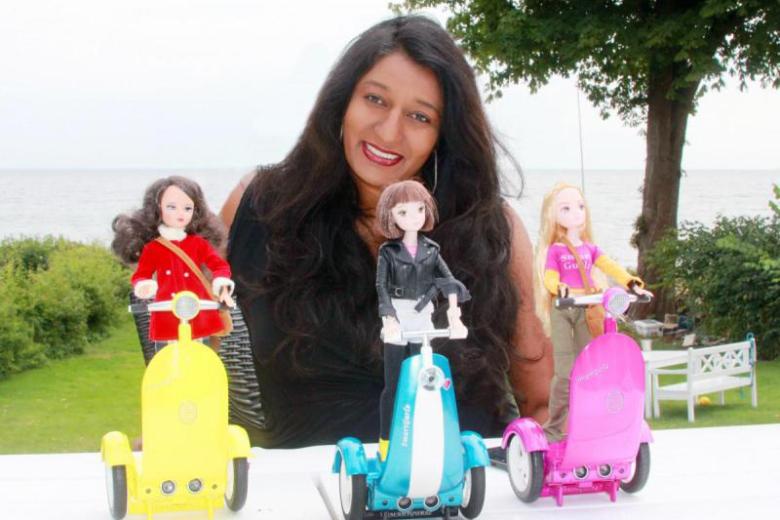 Photo of Sharmi Albrechtsen with three of the SmartGurlz toys
