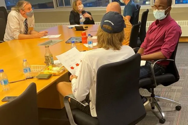 Group of people sitting around a table at a storytelling retreat.
