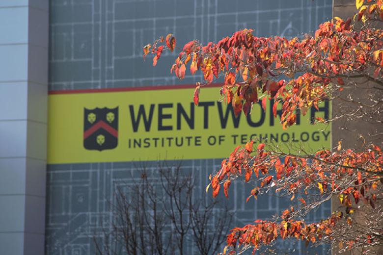 Wentworth sign, framed by fall leaves