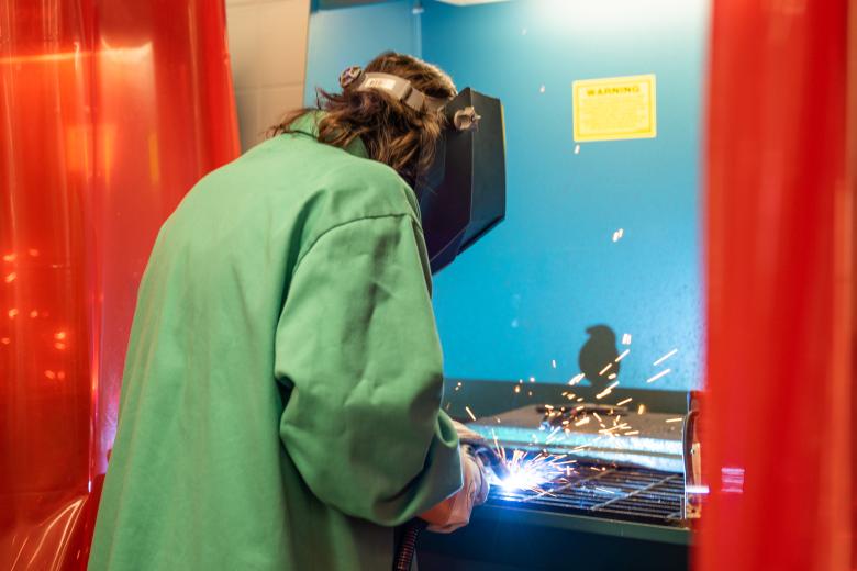 Student using the foundry equipment