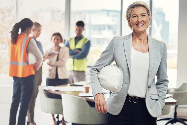 Portrait, construction worker and manager with an engineer woman at work in her architecture office. Industry, design and building with a female architect leader working on a development