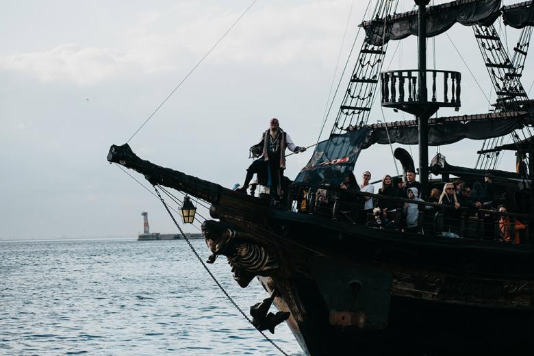 Pirate ship sailing across an ocean