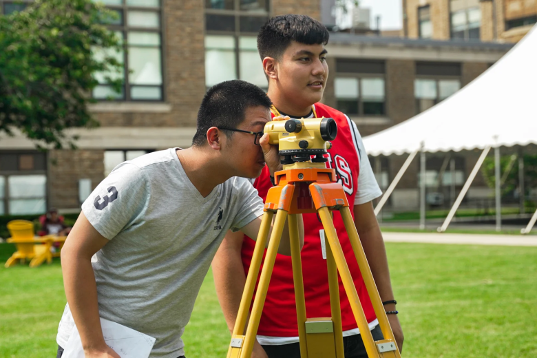 students on the quad surveying 