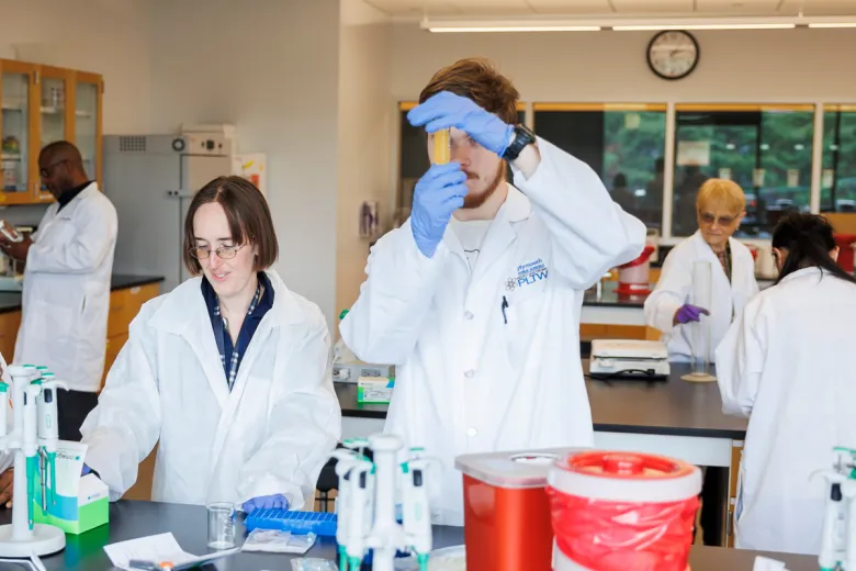 Mary Machado works with bioengineering students in the lab