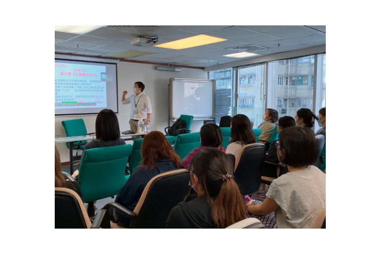 stock photo of students sitting in classroom while teacher lectures